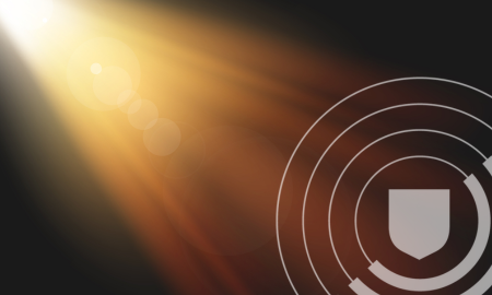 yellow light from a spotlight with shield pattern overlay