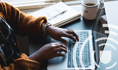 View of someone working on a laptop over their shoulder