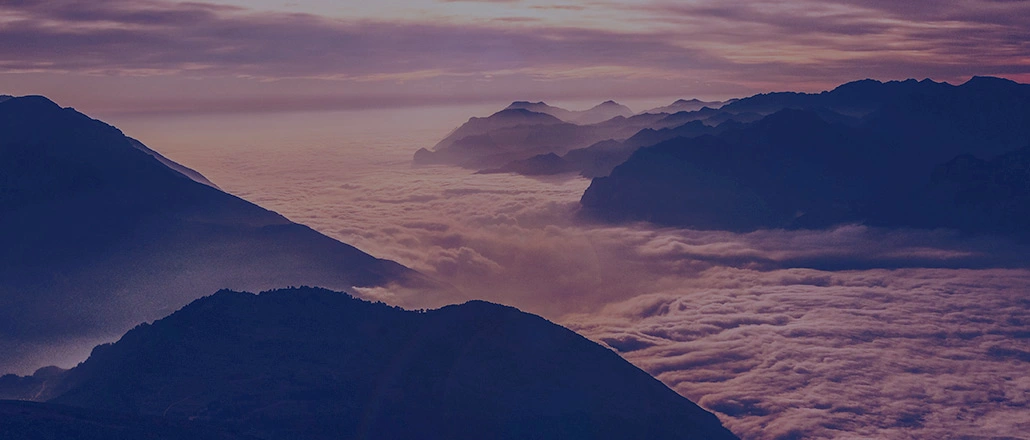 Breath taking scenery with mountain tops covered by clouds