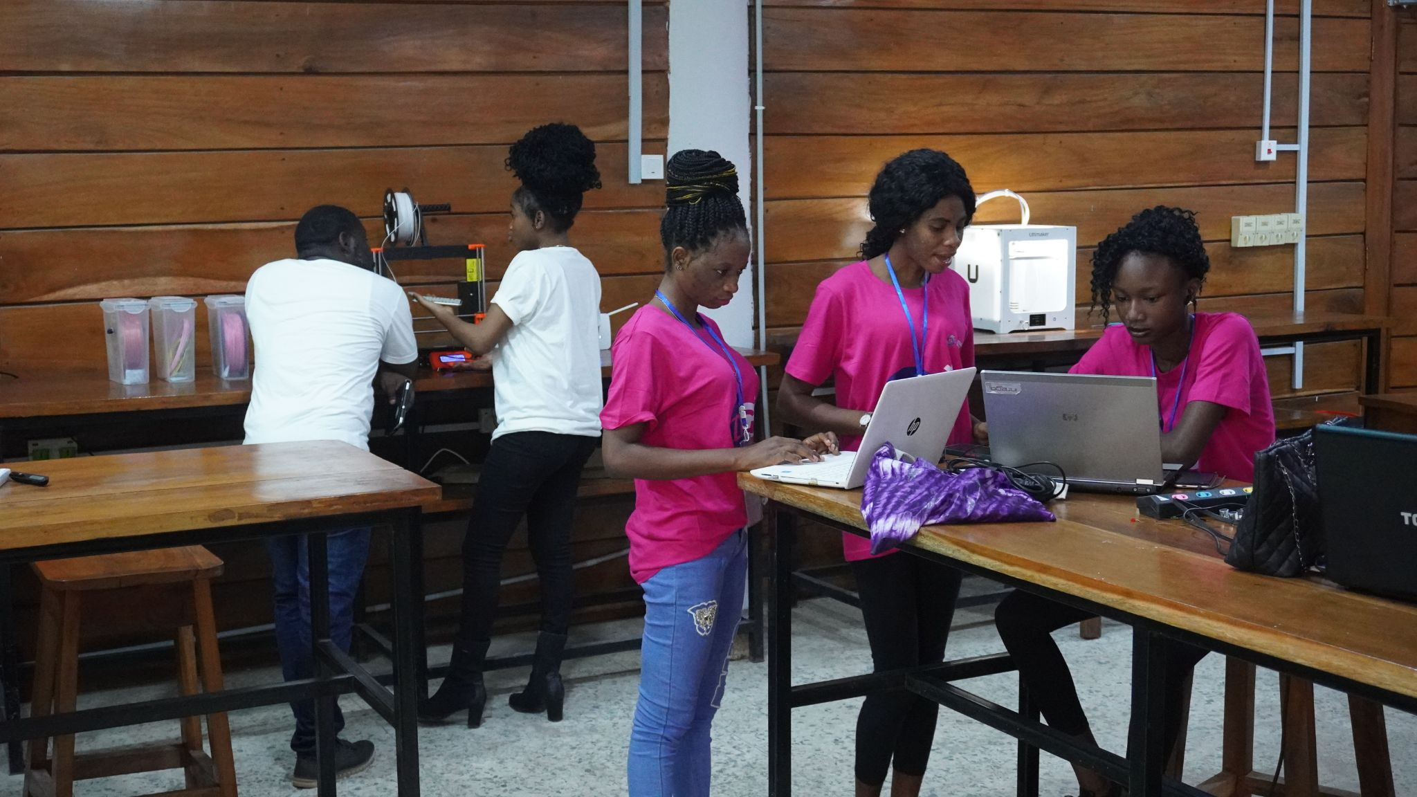 Young women using 3D printers during the Ignite Tech in Girls bootcamp at the UI Design Studio. Prior to the bootcamp, none of the bootcamp participants had previously used (or heard of) 3D printers, CAD software, or even Microsoft PowerPoint.