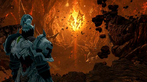 A player character stands, clad in armor, beholding the heart within the giant.