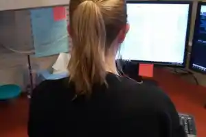 Woman sitting in front of desktop computer