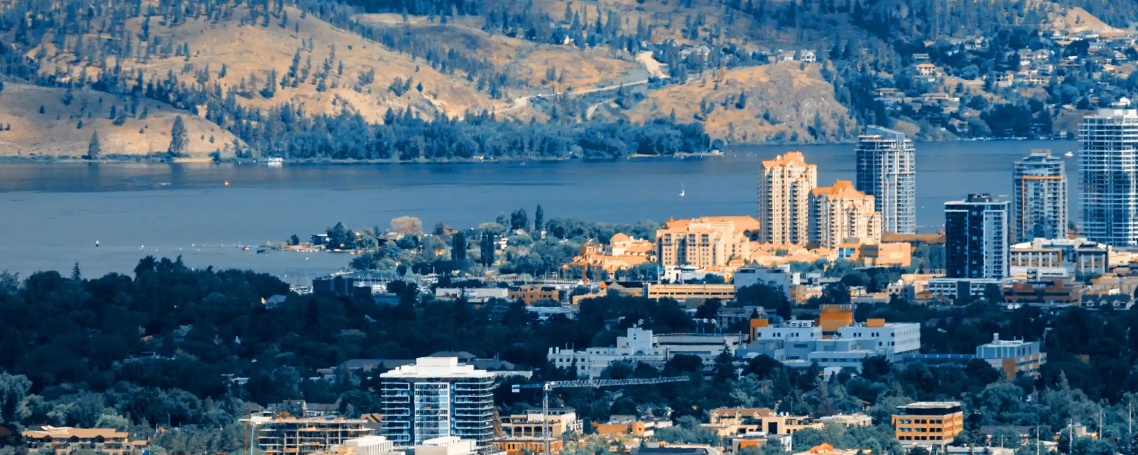City of Kelowna with buildings in foreground and lake in background