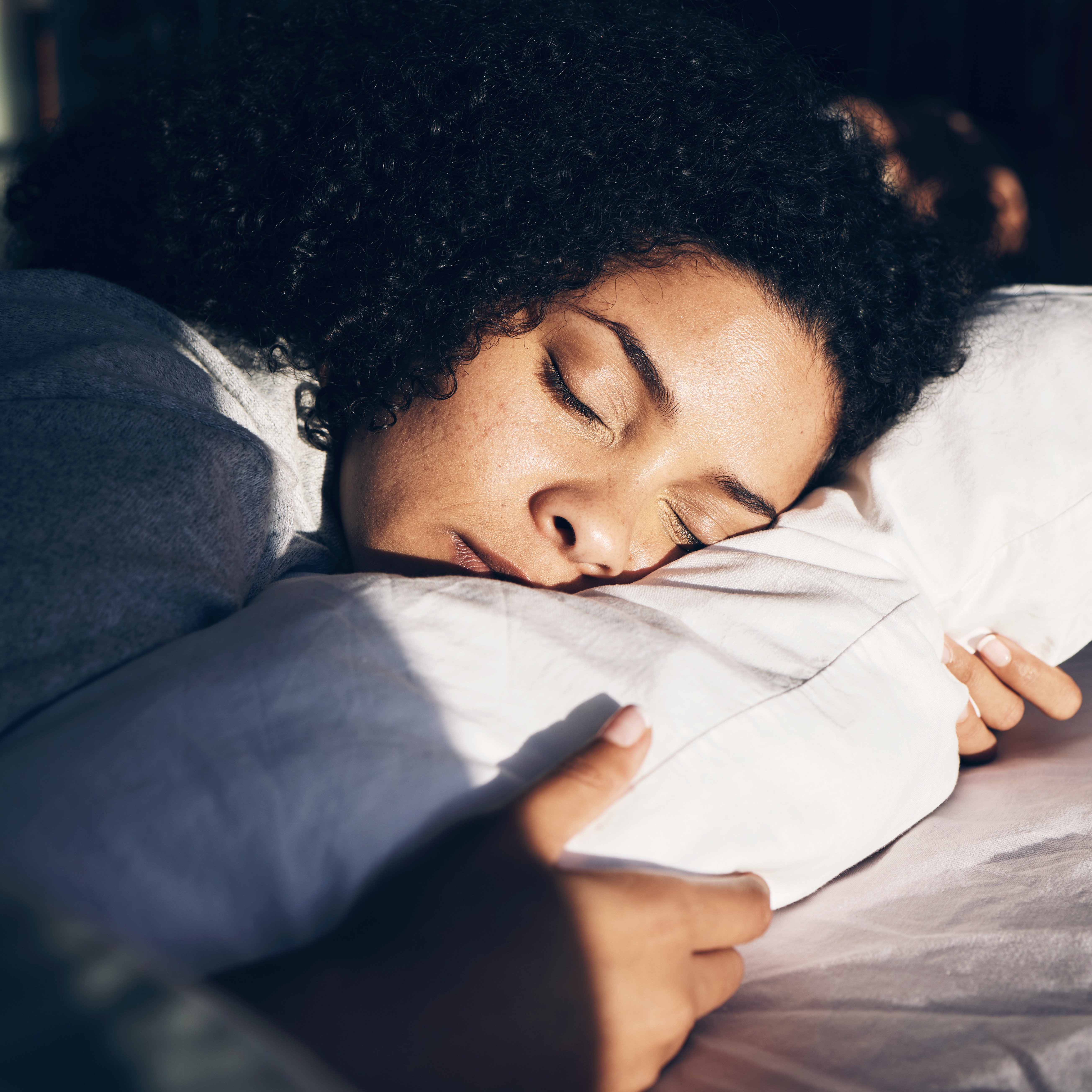peaceful-woman-sleeping-on-white-bedding-indoors-2026-03-25-03-07-48-utc
