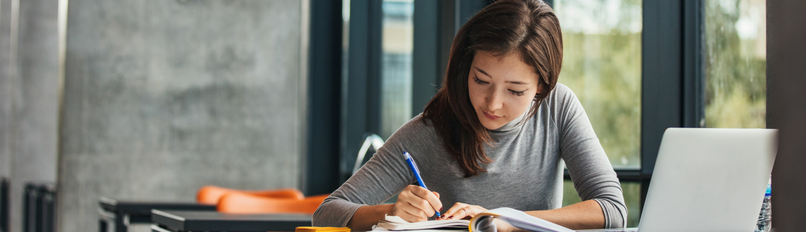 A female test taker prepares for the IELTS test with the official preparation material