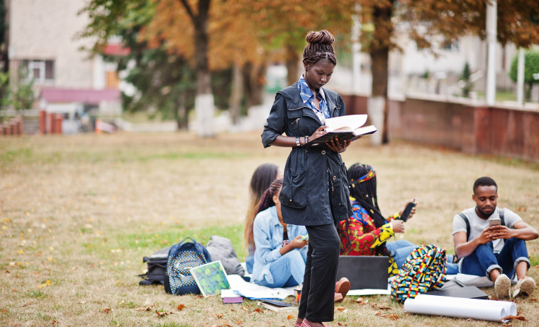 A group of IELTS test takers preparing for IELTS in the lawn of an university