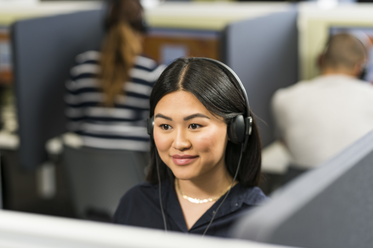 Female test taker takes the IELTS Listening Test on computer