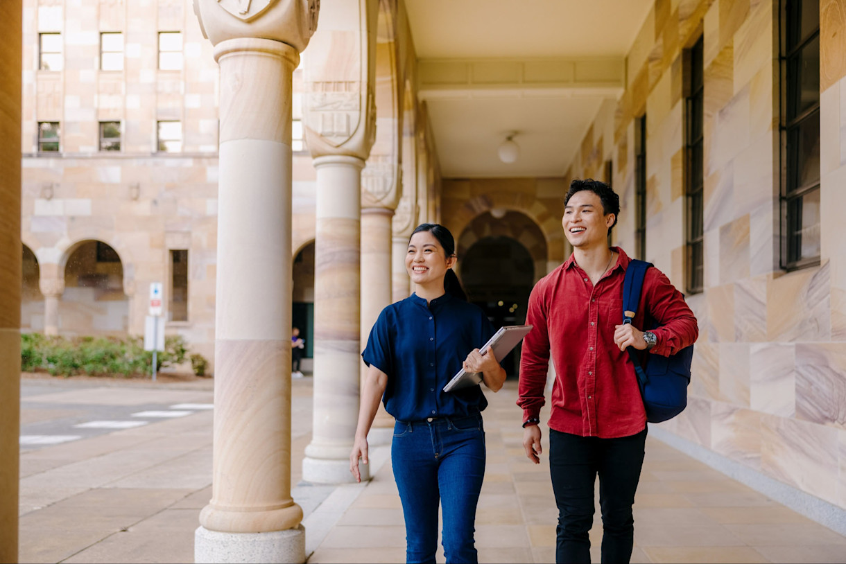 Image - two students walk through university campus - global