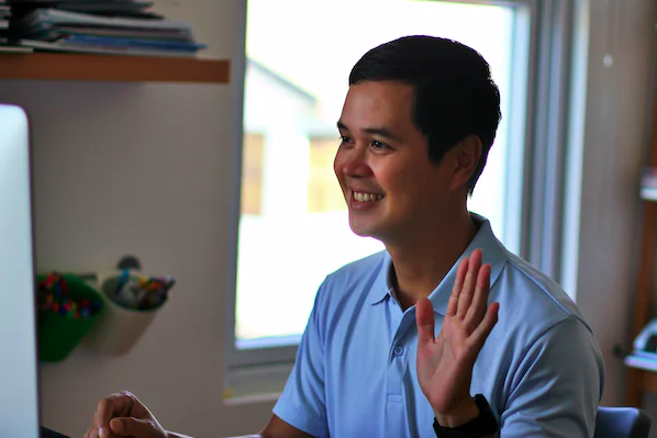 man-speaking-in-front-of-a-computer-practicing-for-IELTS-speaking-test