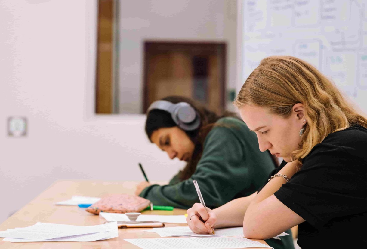 Two test takers preparing for IELTS Listening test.