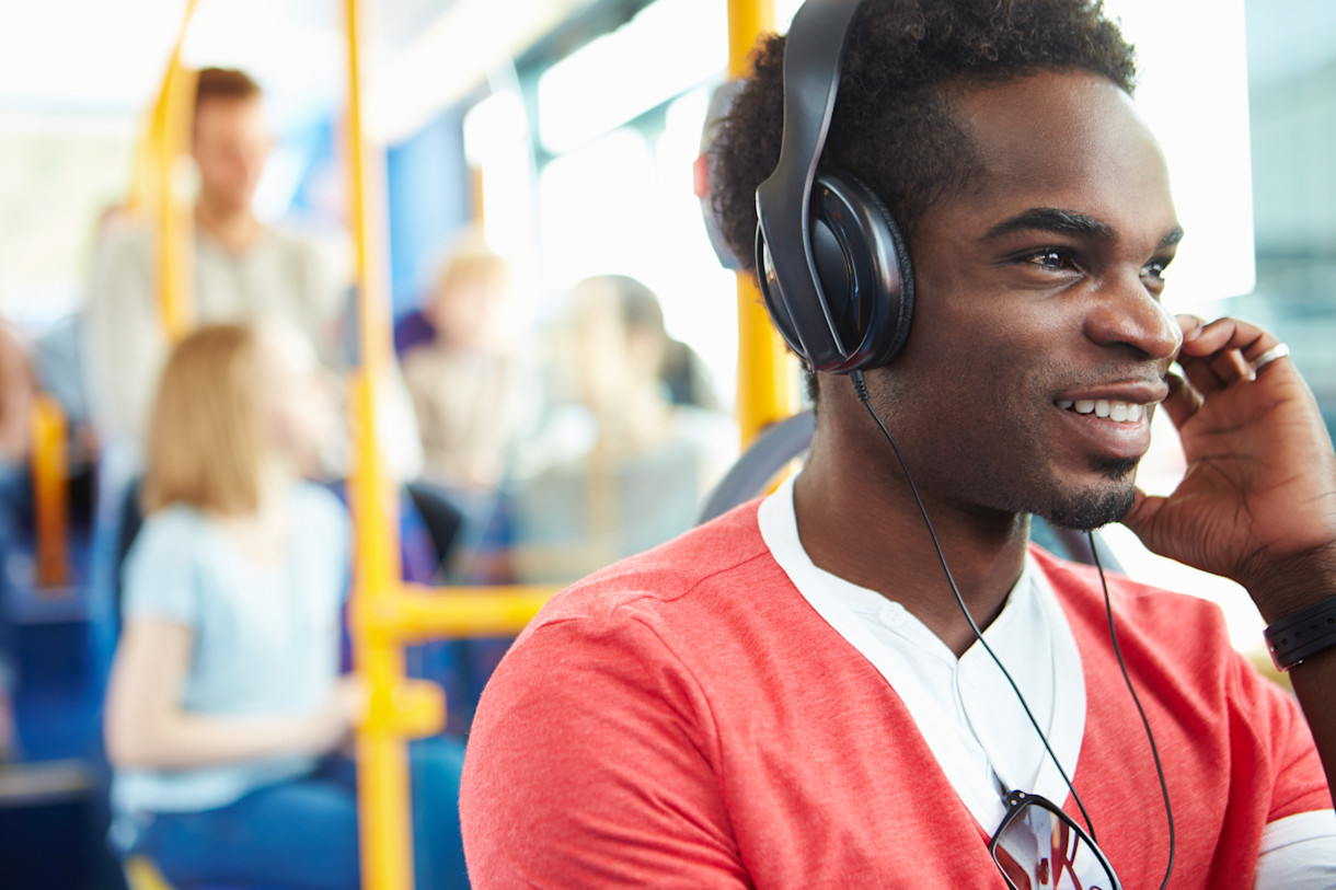 Image - young man with headphones on public transport