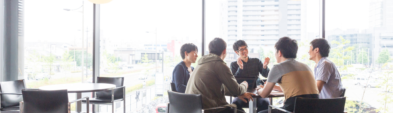 Group of men around a round table, discuss about IELTS