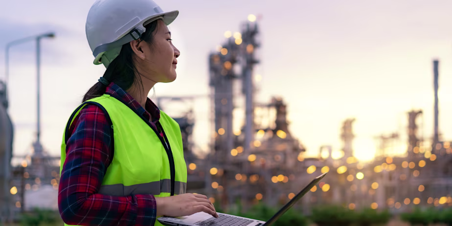 Woman in a hi-vis vest working in trades in New Zealand under new residence pathways with IELTS