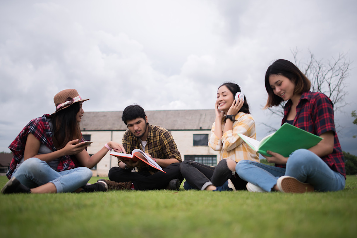 group-of-singaporean-student-sitting-park-after-class-in-Australia