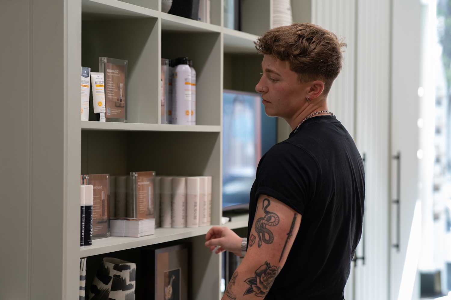 A client browses NAAMA's aftercare for tattoo removal