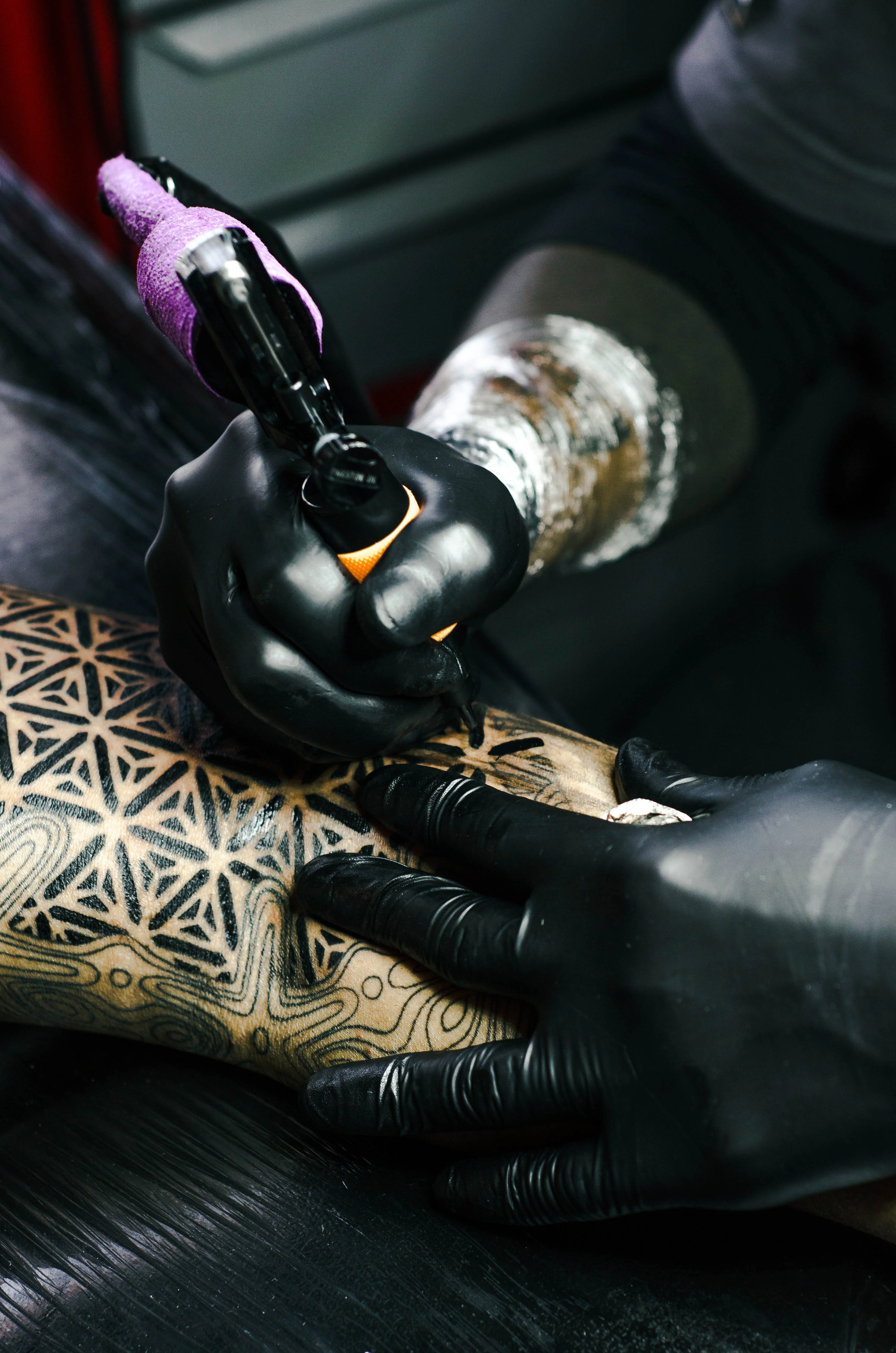 Tattoo artist inking the latest tattoo trends.