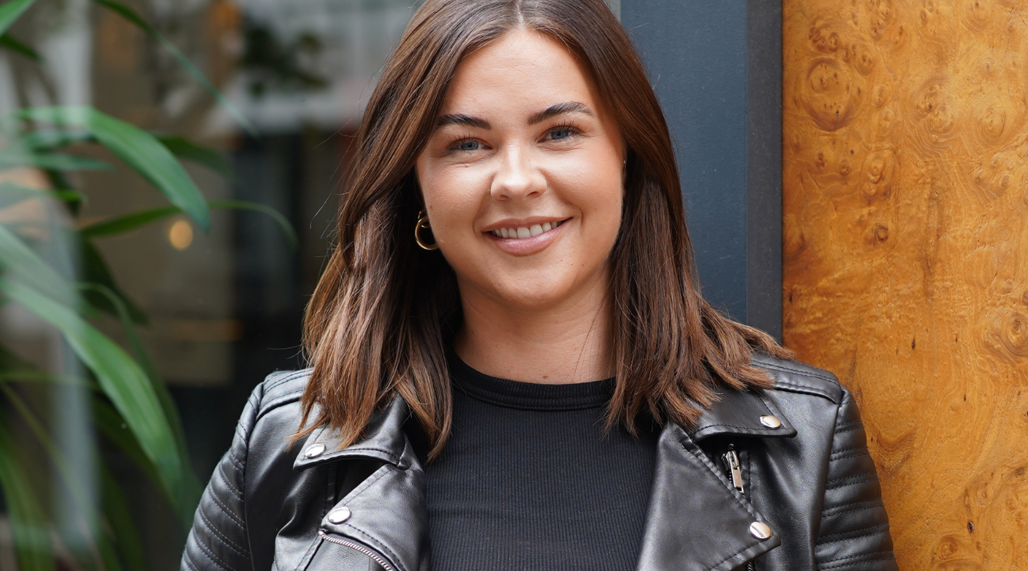 Reality TV star Shelby Tribble smiles at the camera outside NAAMA Tattoo Removal Studios in London
