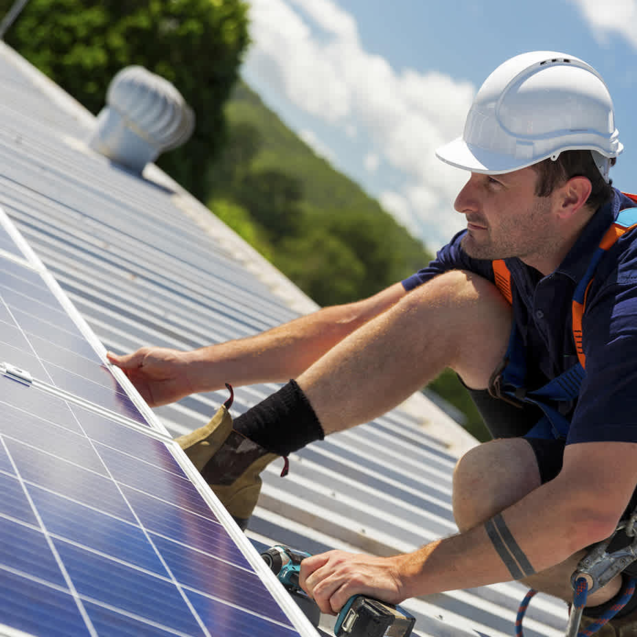 Installateur befestigt Solaranlage auf Dach