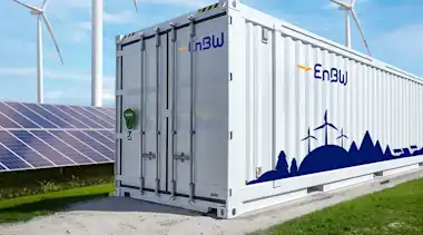 EnBW Container Batteriespeicher; Solarpark mit Solarpanel und Windräder im Hintergrund