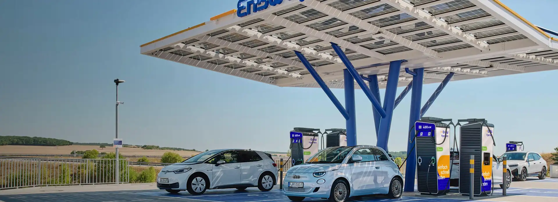 EnBW Hypernetz Ladepark weiße Elektroautos am Laden blauer Himmel