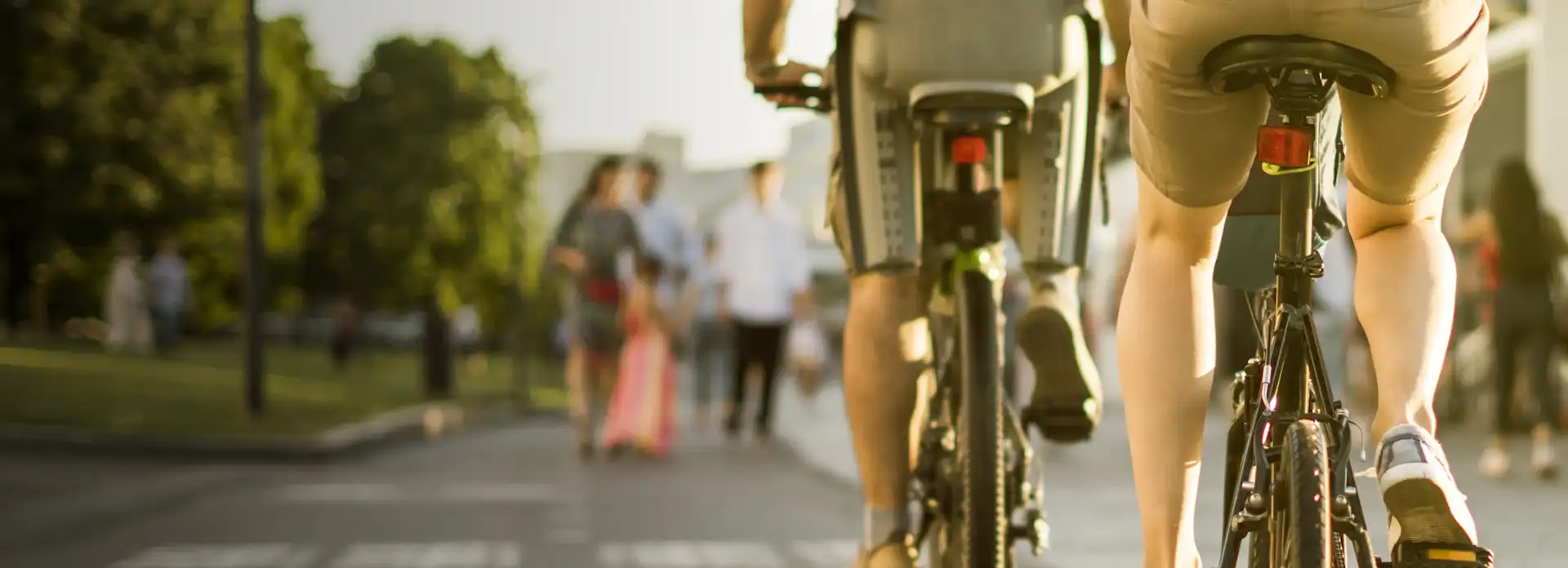 Zwei Personen fahren mit dem Fahrrad durch eine Fußgängerzone