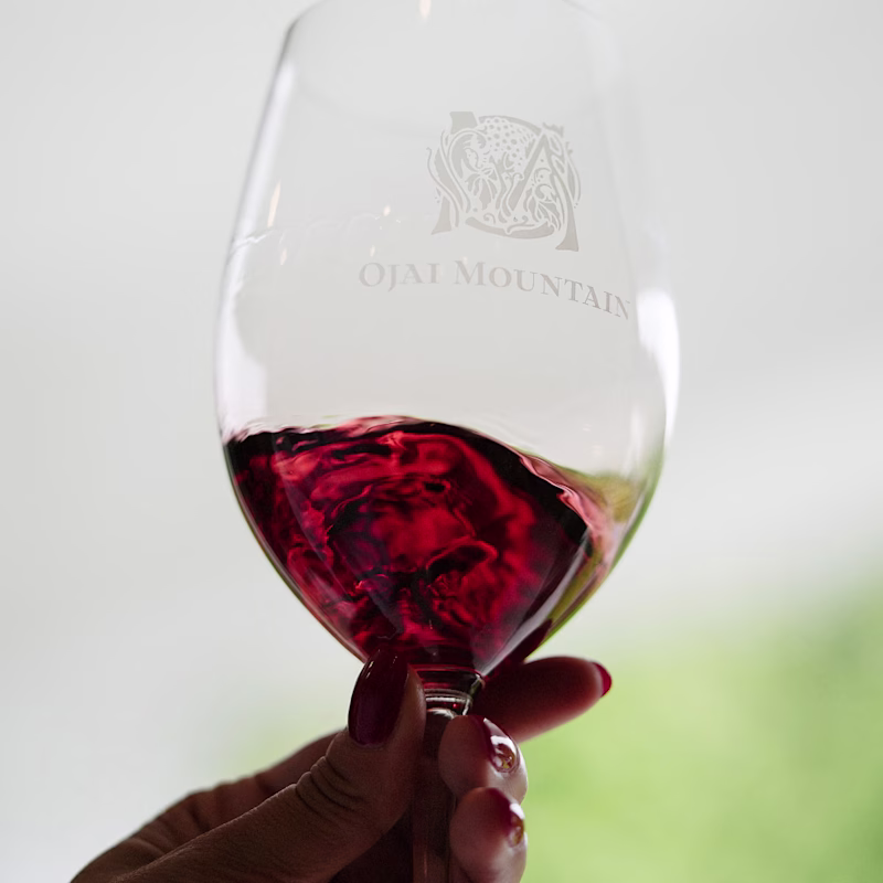 2023 Mourvèdre Gallery Image 06 Hand swirling red wine in an etched Ojai Mountain tasting glass
