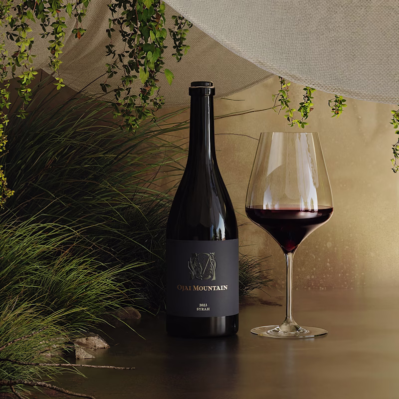 Ojai Mountain 2023 Syrah with a poured glass among tall grasses