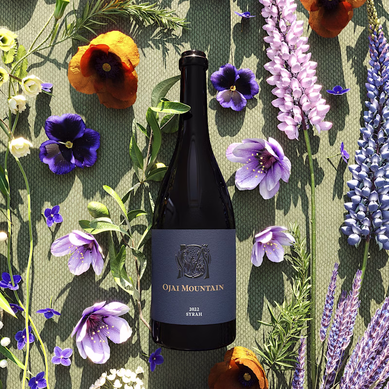 Ojai Mountain 2022 Syrah surrounded by purple wildflowers and poppies