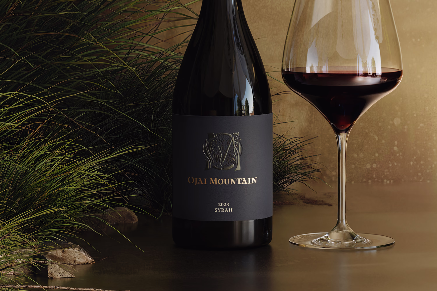 Ojai Mountain 2023 Syrah bottle and poured glass on a golden outdoor table Ojai Mountain 2023 Syrah bottle and poured glass on a golden outdoor table