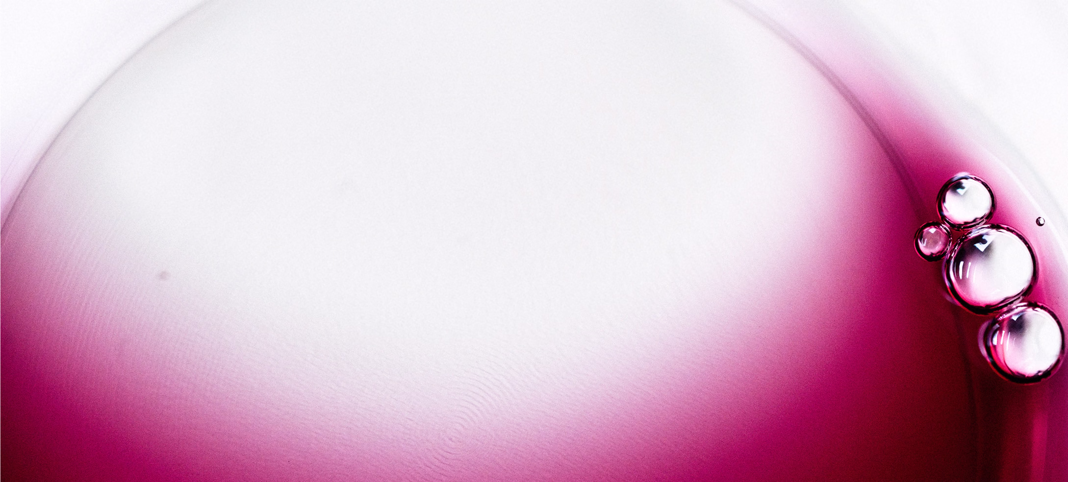 Close view of red wine with fine bubbles gathered at the rim