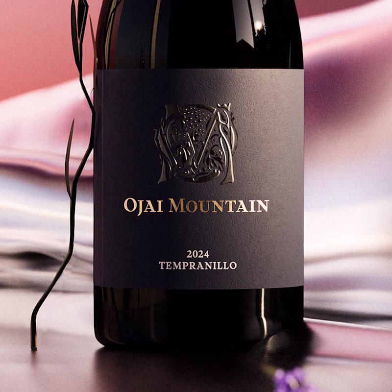 Close-up of the Ojai Mountain 2024 Tempranillo label with lavender on pink silk