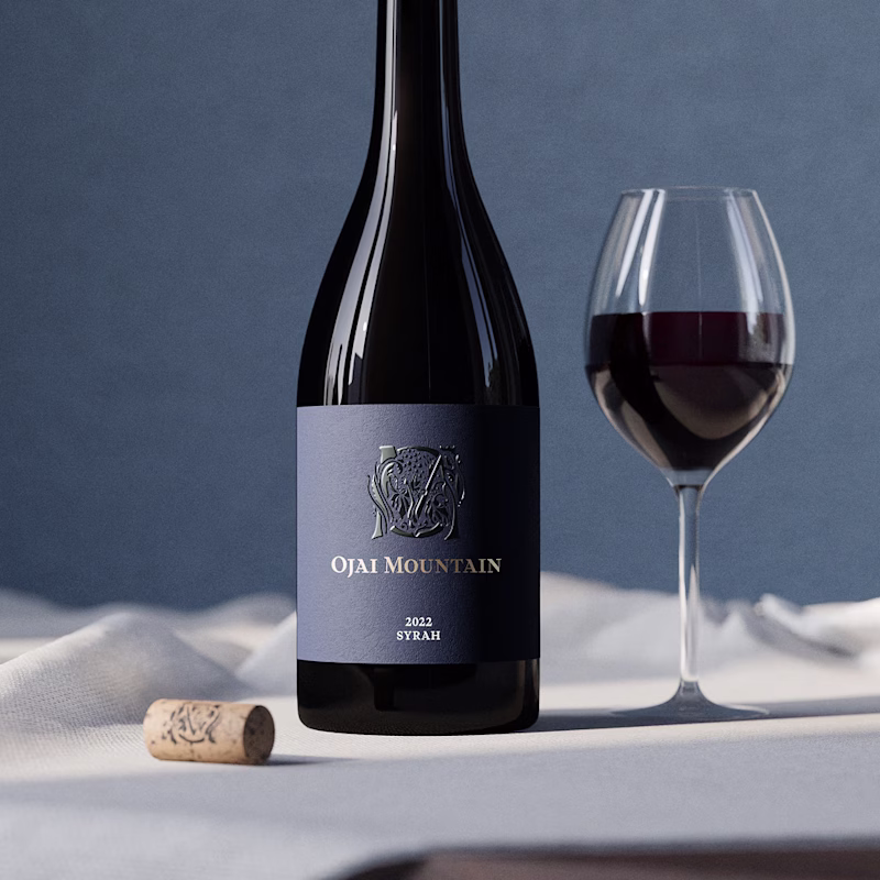 Ojai Mountain 2022 Syrah bottle beside a poured glass and cork