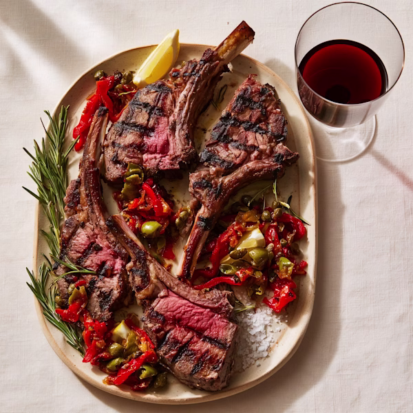 Grilled Lamb Chops with Olive and Pepper Relish Grilled lamb rib chops with roasted pepper and olive relish on cream platter