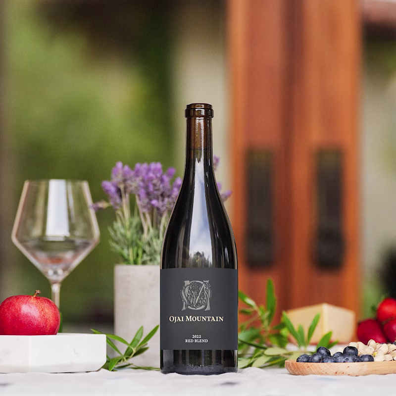 Ojai Mountain 2022 Red Blend on a table with lavender, fruit and cheese Ojai Mountain 2022 Red Blend on a table with lavender, fruit and cheese