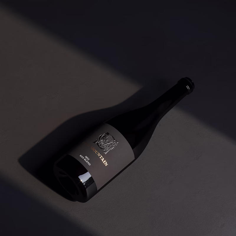 Ojai Mountain 2021 Red Blend lying on a dark surface in hard light