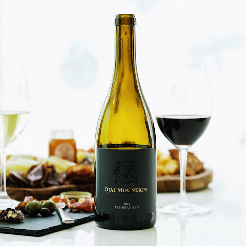 Ojai Mountain white and red wines poured beside a charcuterie board with olives