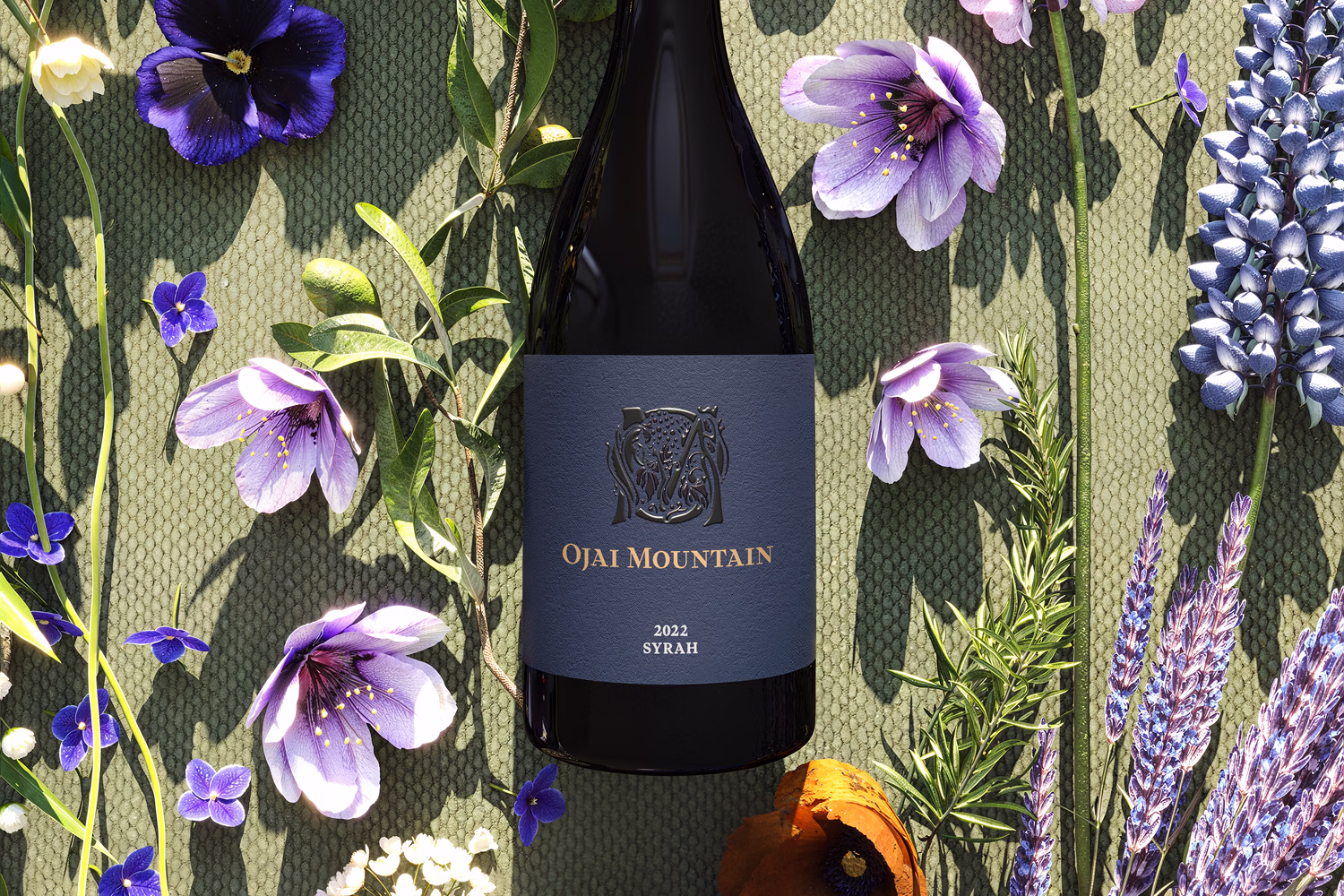 Ojai Mountain 2022 Syrah bottle styled with purple wildflowers and lavender Ojai Mountain 2022 Syrah bottle styled with purple wildflowers and lavender