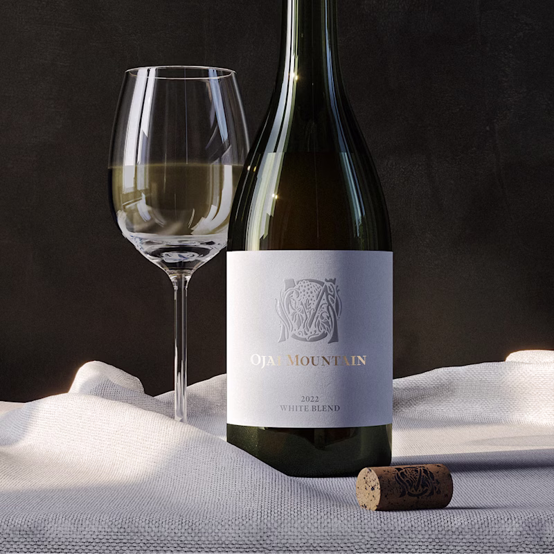 Ojai Mountain White Blend bottle beside a poured glass and cork