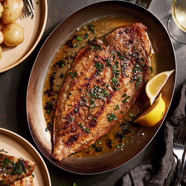 Dover Sole Meunière in the Pan Pan-fried Dover sole in browned butter with parsley and lemon beside new potatoes
