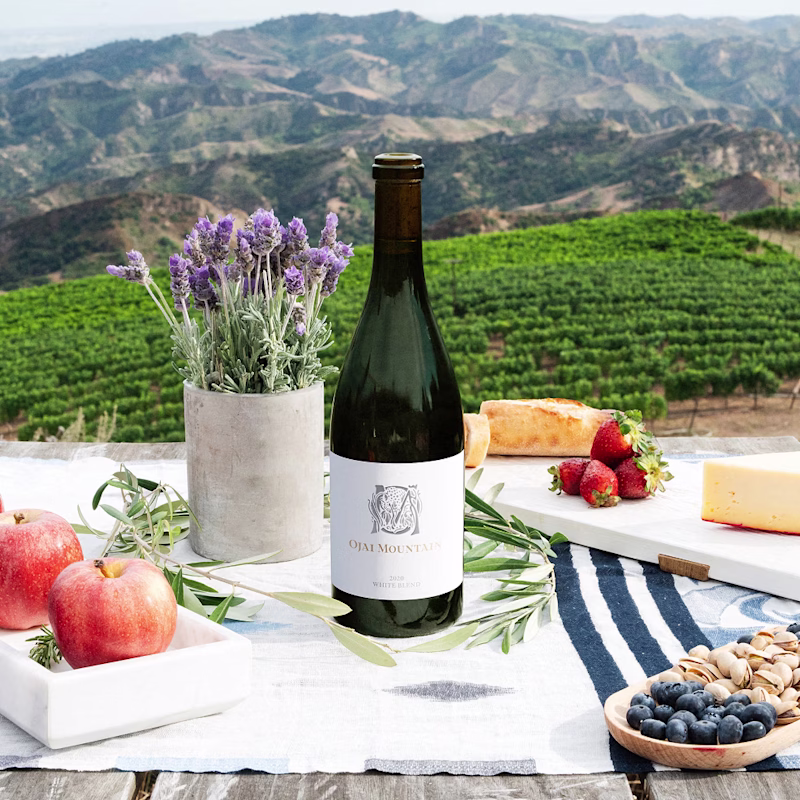 Ojai Mountain 2020 White Blend on a picnic table above the vineyard