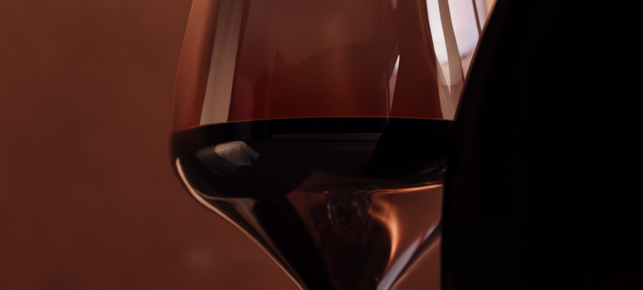 Red wine poured in a glass against a dark warm background
