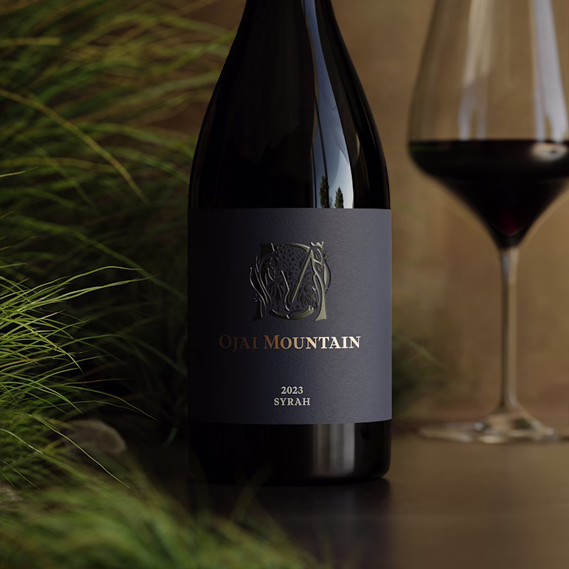 Ojai Mountain 2023 Syrah bottle standing among fine green grasses