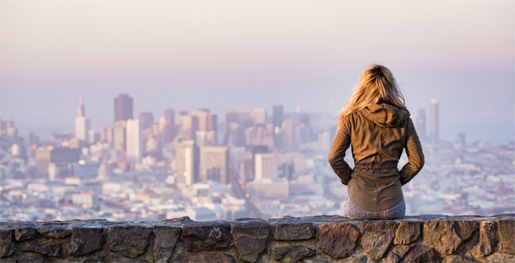 An individual overlooking a cityscape environment.