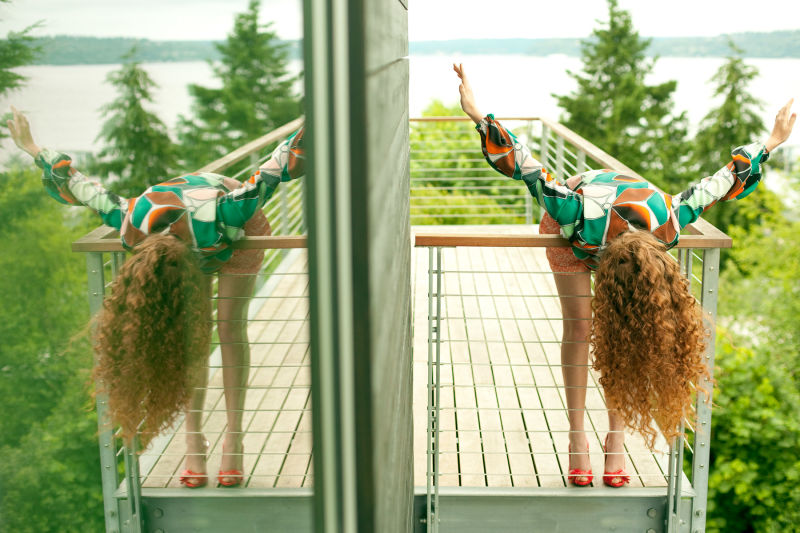 Woman hanging over balcony