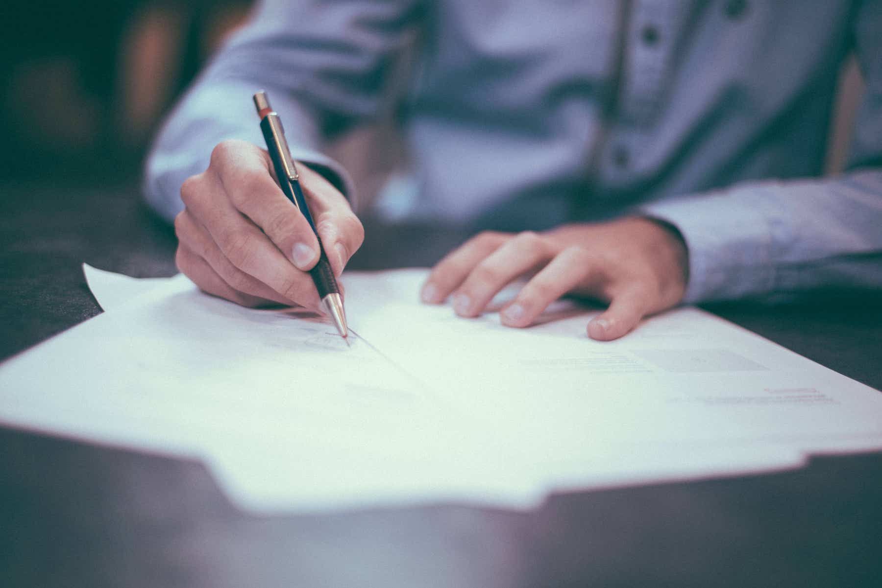 an estate agent points out contract terms with pen