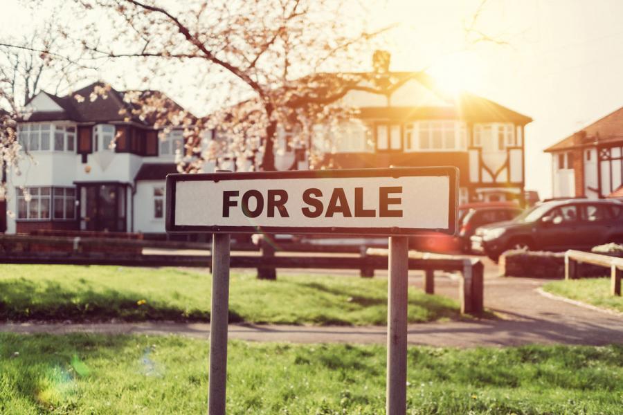 a for sale sign outside a house in England