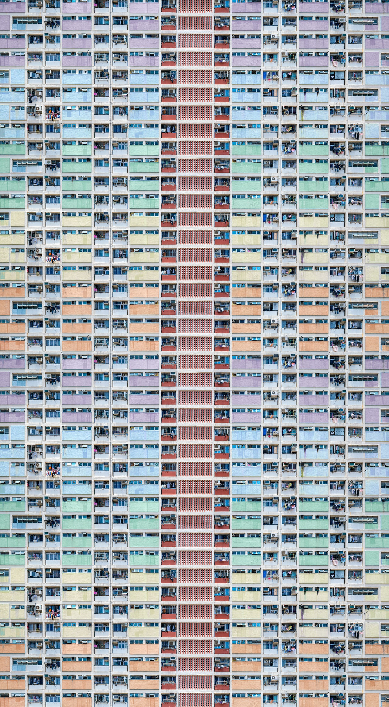 tall apartment block painted in pastel stripes 