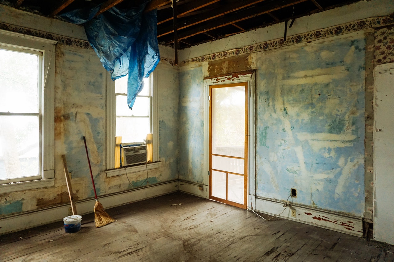 empty room in fixer upper house with bare walls and flooring that have been prepared for renovations to start