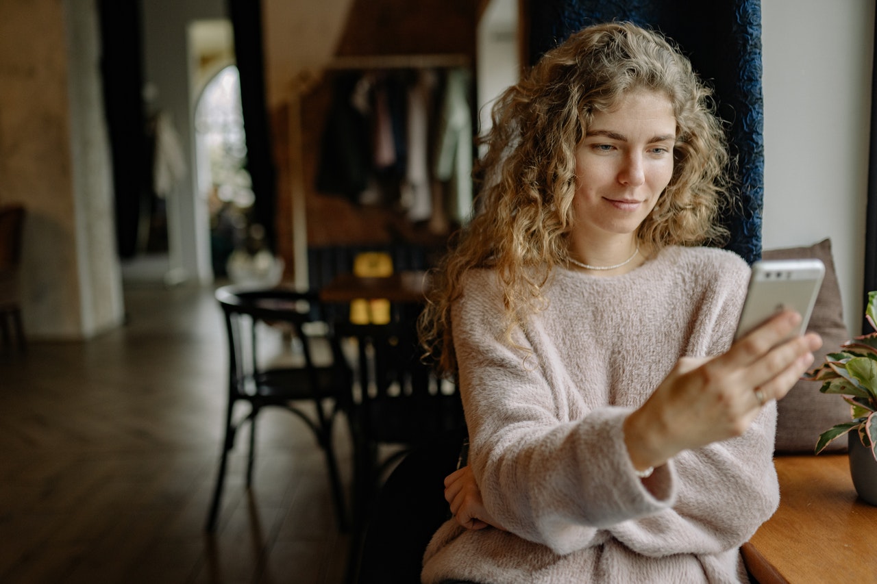Young woman browsing the internet on her smartphone.
