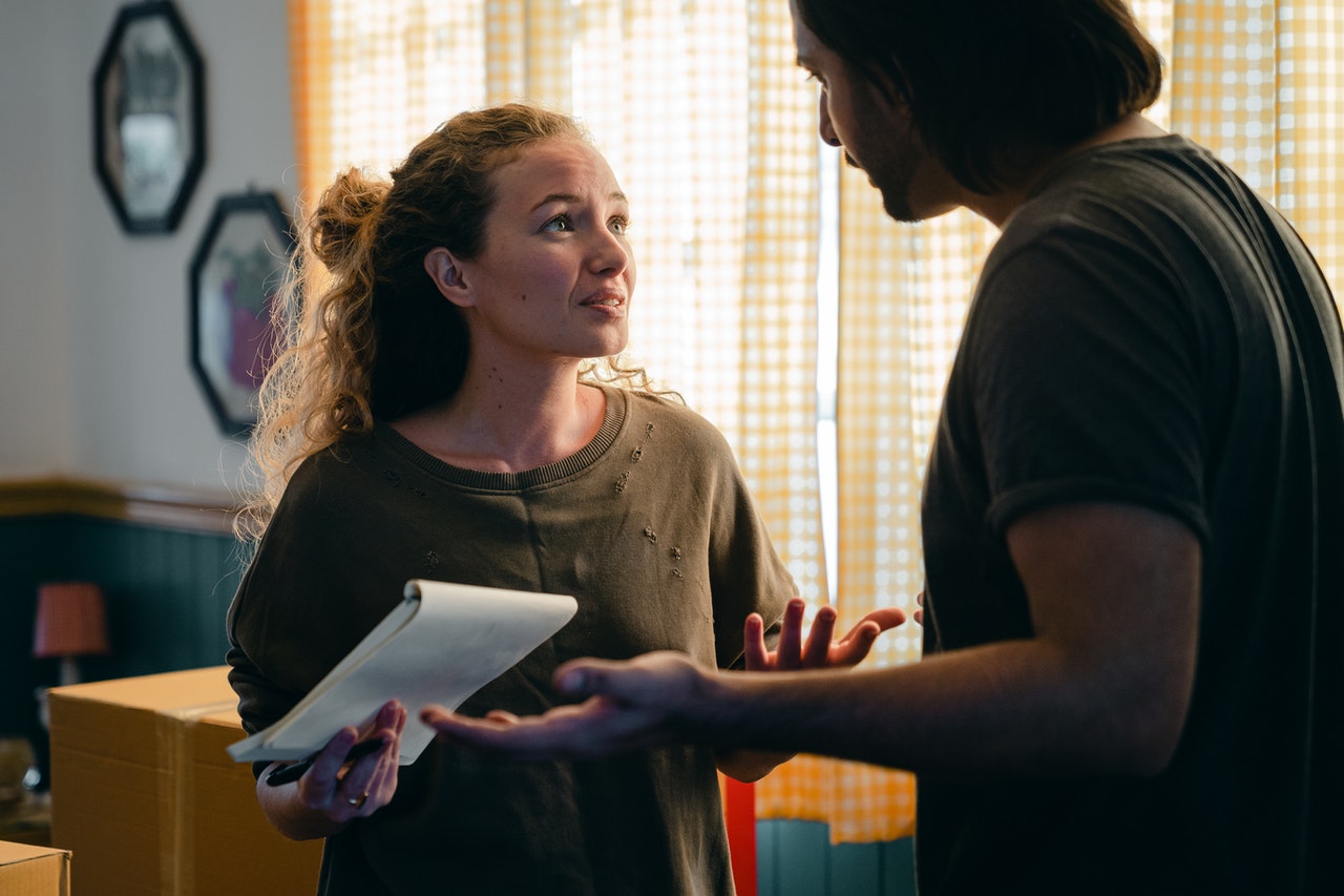 Concerned couple are talking about the contents of a notepad